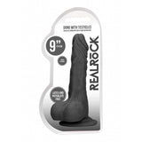 Realrock 9 Inch Dong With Testicles Realistic Black in packaging showcasing its design and features.