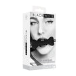 Ouch Silicone Bone Gag with Bonded Leather Straps packaging featuring a model using the gag for playful restraint.