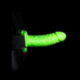Ouch Realistic 7 inch Strap-on Harness Glow In The Dark showing a glowing green insertable for adventurous couples.