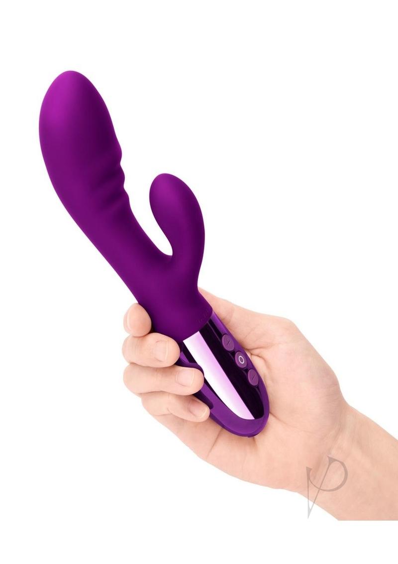 Le Wand Blend Rechargeable Silicone Rabbit Vibrator Cherry held in hand, showcasing its design and dual motors.