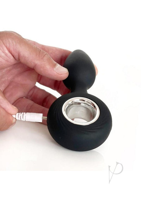 Vers Plug Vibrating Rechargeable Silicone Anal Plug Black being held while charging.