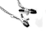 STRICT Silicone Ball Gag with Nipple Clamps Black featuring black clamps connected by a metal chain.