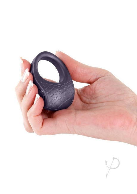 Hand holding the Seduction Levi Rechargeable Silicone Cock Ring Gray, showcasing its sleek design and texture.
