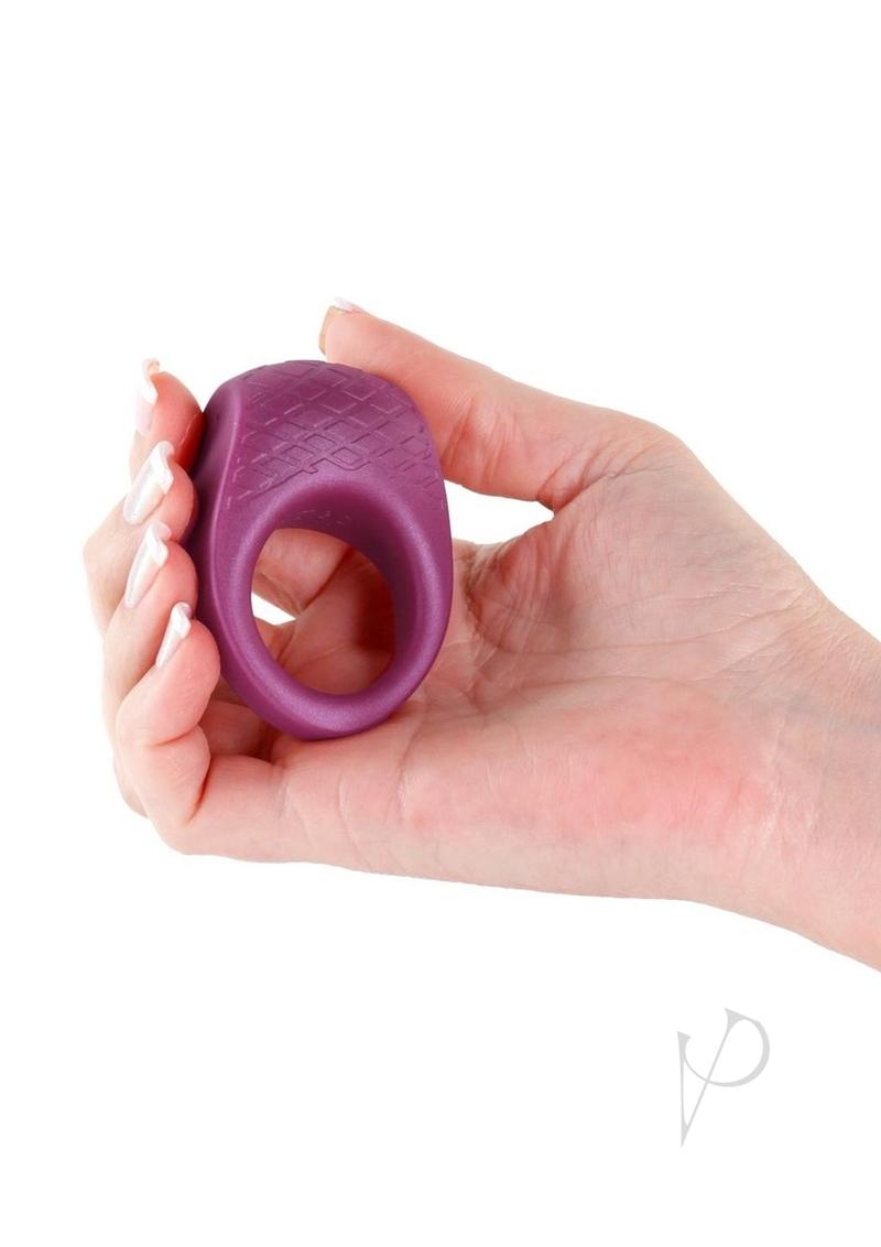 Seduction Levi Rechargeable Silicone Cock Ring Red held in hand, showcasing flexible and body-safe silicone material.