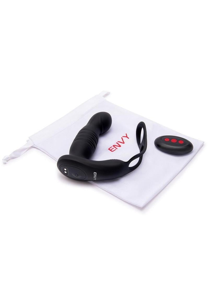 Envy Thruster P-Spot Vibrator & Ring with Remote Control lying next to its remote and storage pouch.