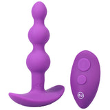 A-Play Beaded Vibe Silicone Anal Plug With Remote Purple next to its wireless remote for anal exploration.