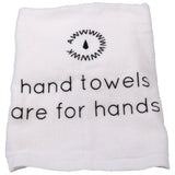 White hand towel with the text 'hand towels are for hands' printed on it.