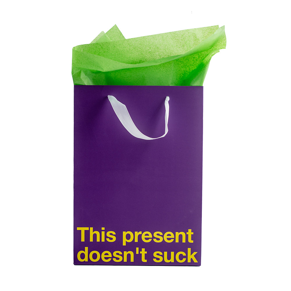 This Present Doesn't Suck Color Gift Bag Purple with green tissue paper for a humorous gift option.