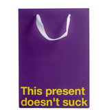 This Present Doesn't Suck Color Gift Bag Purple featuring a humorous design for Gift giving.