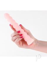 A person holding the Pure Joy Rechargeable Silicone Vibrator Orange with a smooth, textured design.