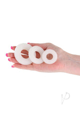 Firefly Bubble Ring Glow in the Dark Cock Ring Set White displayed in hand, showcasing three soft silicone rings.