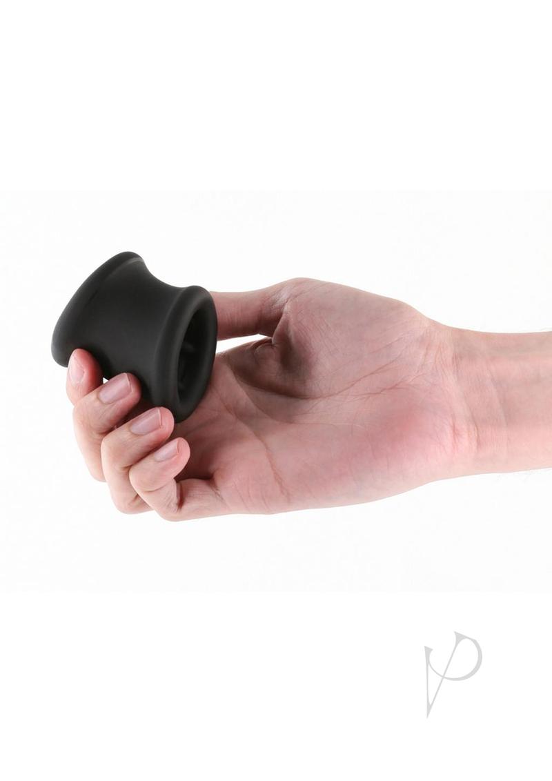 Renegade Suave Silicone Ball Stretcher Cock Ring Black held in hand on a white background.