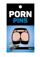WoodRocket Butt Enamel Pin Black/Vanilla on a packaging featuring a humorous butt illustration.