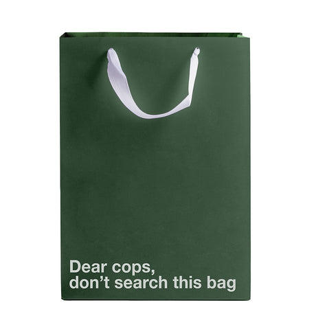 Green gift bag with white ribbon handle featuring text: Dear Cops Don't Search This Bag.