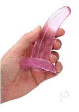 RealRock Crystal Clear 4.7 Inch Suction Cup Dildo Pink held in hand, showcasing its translucent design.