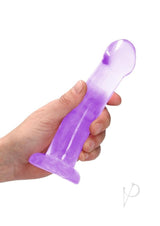 RealRock Crystal Clear 6.7 inch Suction Cup Dildo Purple held in hand showing its translucent design.