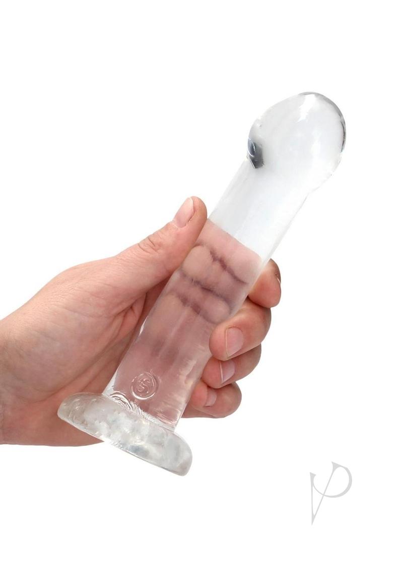 RealRock Crystal Clear Dildo Suction Cup 6.7 Inch Clear held in hand, translucent design showcasing smooth contours.