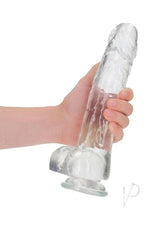 RealRock Crystal Clear Realistic Dildo with Balls 10 inch held in hand, showcasing its lifelike design and suction base.