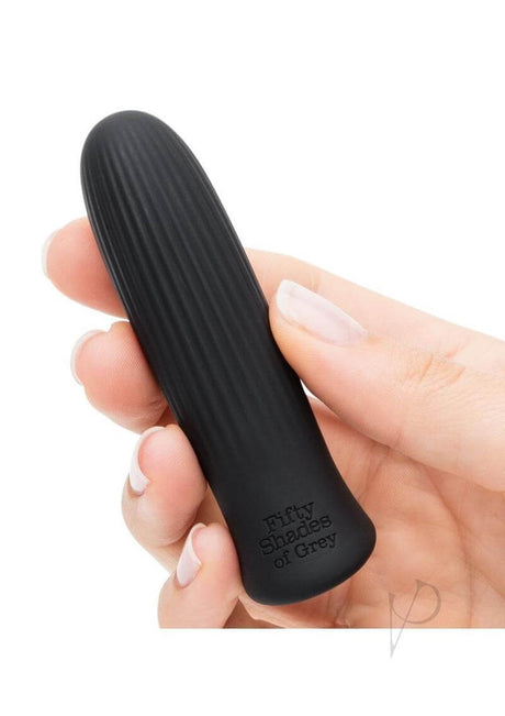 Fifty Shades of Grey Sensation Bullet Vibrator Black held in a hand, featuring a smooth, sleek design for discreet pleasure.