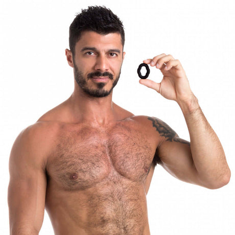 Sport Fucker Vigor Ring Liquid Silicone Cock Ring held by a shirtless man, showcasing its design for enhanced performance.