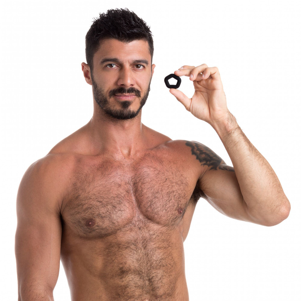 Man holding Sport Fucker Pentagon Silicone Cock Ring, highlighting its snug fit and premium silicone material.