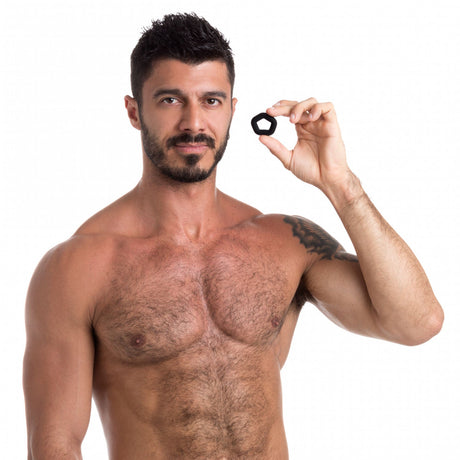 Man holding Sport Fucker Pentagon Silicone Cock Ring, highlighting its snug fit and premium silicone material.