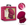 Blush Riana Mulberry Wine Clitoral Stimulator in packaging with user demonstration of its ergonomic design.