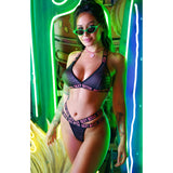 Sexy Bitch Reptile Bralette & Strappy Panty Set showcased with striking reptile print against vibrant neon backdrop.