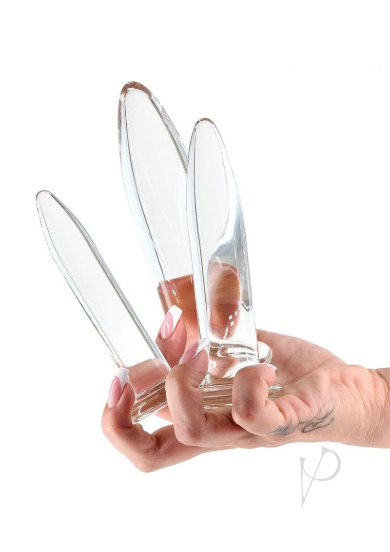 Person holding Crystal Trainer Glass Anal Plugs Kit 3pc Set Clear showcasing the three graduated plugs.