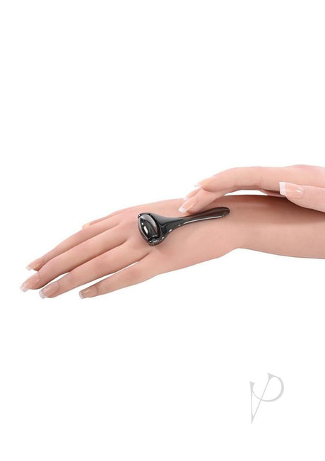 Sex and Mischief Ex's & Oh's Temperature Play Roller Black being used on a hand for temperature play stimulation.