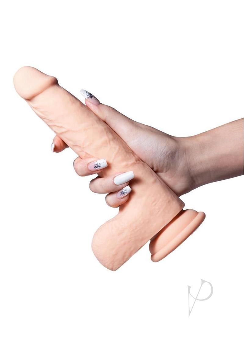 Luis App Controlled Thrusting Dildo Clit Licker Caramel held in hand showcasing its realistic design and suction cup base.