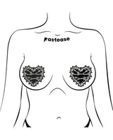 Image of Pastease Premium Barbed Wire Heart Reflective Black OS worn as pasties on a model's chest.
