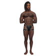 Male Power Scorpio Leather Chastity Thong Black displayed on a muscular model with a confident pose.