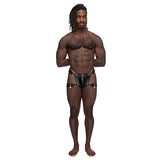 Male Power Scorpio Leather Chastity Thong Black displayed on a muscular model with a confident pose.