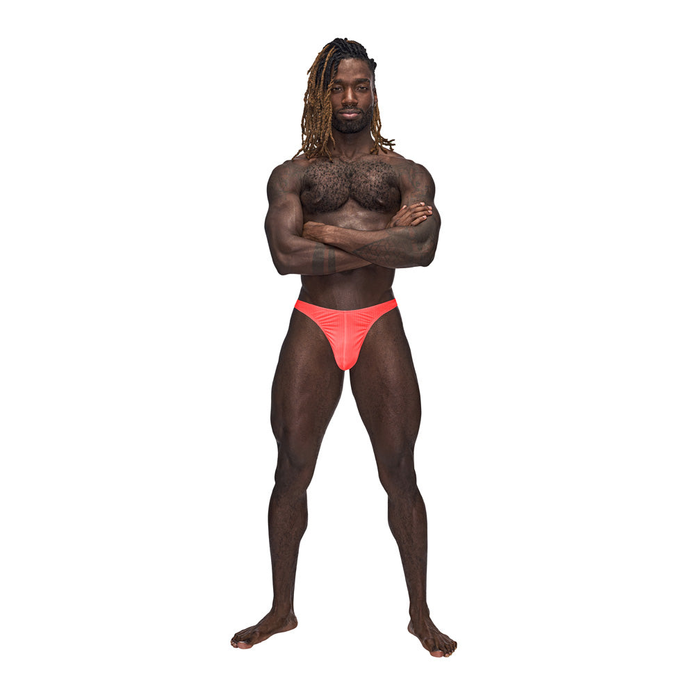 Barely There Bong Thong Coral S M on a muscular model, showcasing confidence and a flattering fit.