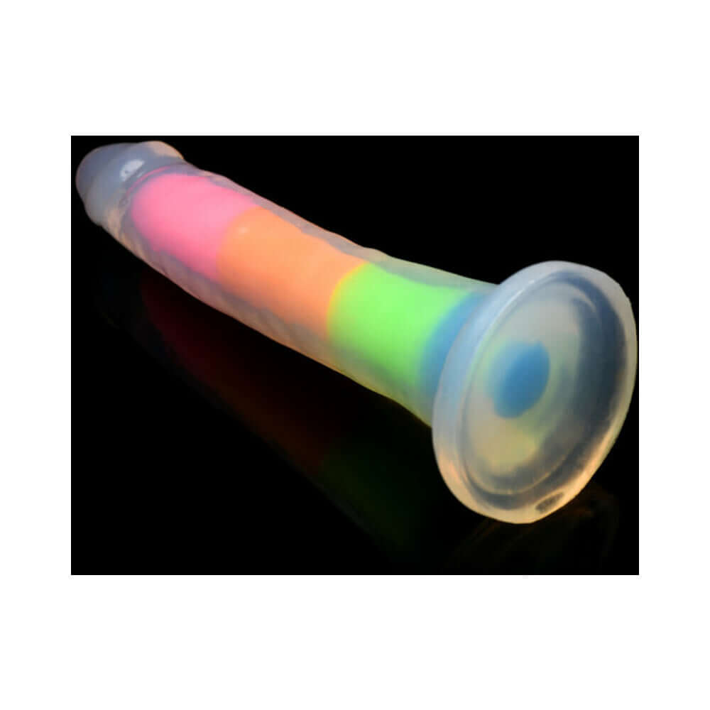 Lollicock Silicone Dildo 7 inch Rainbow Glow in the Dark displayed on a dark background, showcasing its colorful design.