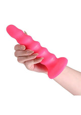 Colours Twist Silicone Dildo with Suction Cup 6.5 Inch Pink held in a hand, showcasing its soft, contoured design.