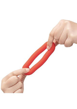 B-Vibe Flex Ring Bulk Silicone Cock Ring Red held between two hands, showcasing its flexible design and silicone material.