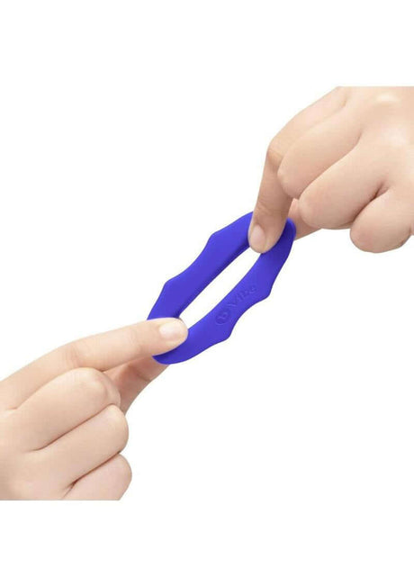 B-Vibe Flex Ring Hex Silicone Cock Ring Blue shown in hands demonstrating flexibility and durability.