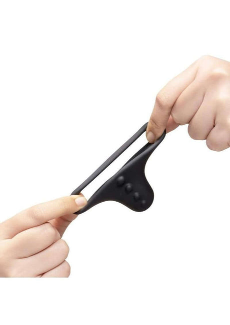 B-Vibe Flex Ring Shaft Silicone Cock Ring & Ball Stretcher Black being stretched by hands, showing its flexibility and comfort.