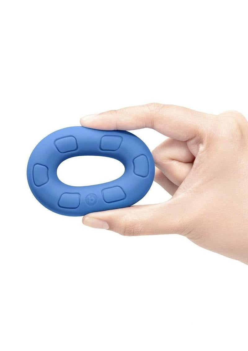 B-Vibe Flex Ring Ultra Soft Silicone Cock Ring Blue held in hand, showcasing its smooth finish and comfortable design.