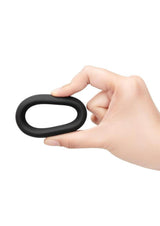 B-Vibe Snug Ring Silicone Cock Ring 40 mm Black held in hand showing its comfortable and durable design.