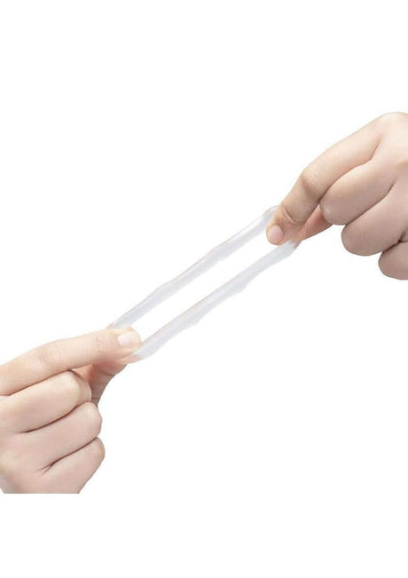 B-Vibe Stretch Tech Bolt Ultra Stretchy Cock Ring Clear being stretched between hands, showcasing its flexibility.