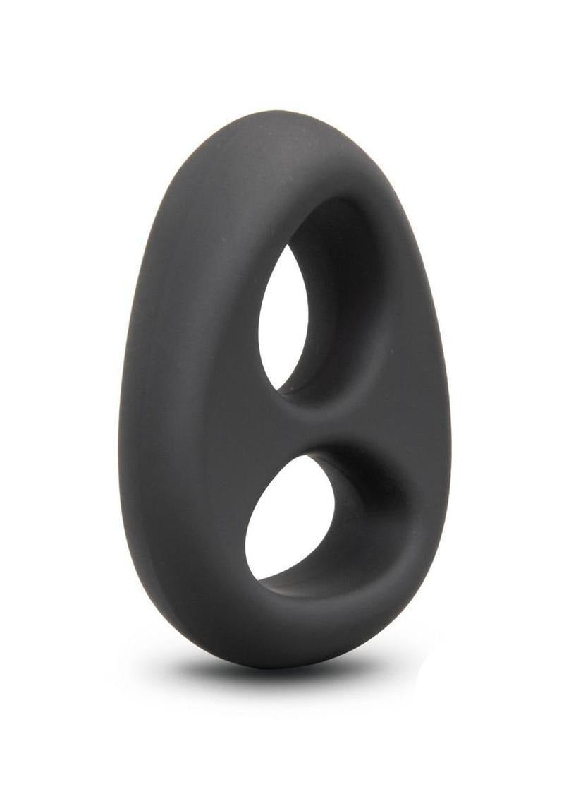 B-Vibe Flex Ring Eight Silicone Cock Ring Black displayed at an angle on a smooth surface.