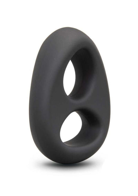 B-Vibe Flex Ring Eight Silicone Cock Ring Black displayed at an angle on a smooth surface.