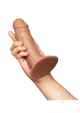 Together Realistic Dildo with Suction Base 6.5 Inch Caramel held in hand showcasing its realistic design and color.