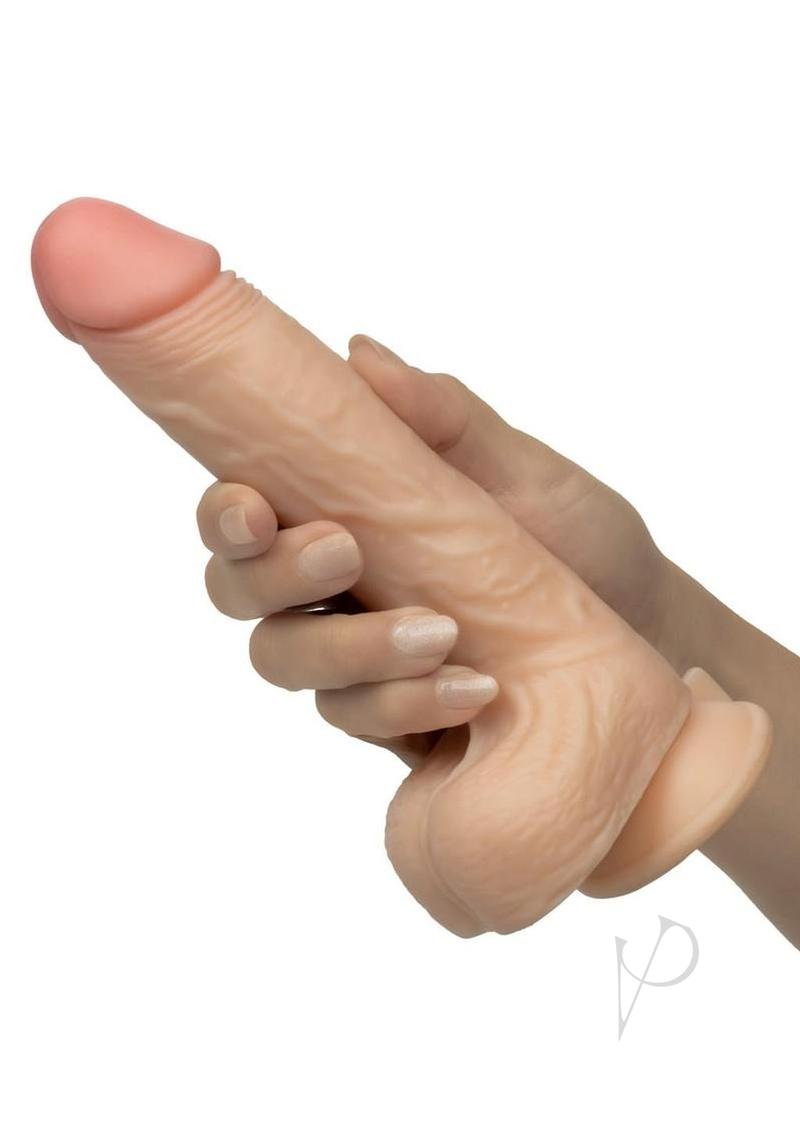 Working Stiff The Vibrating Surfer Vibrating Dildo Vanilla held in a hand, showcasing its lifelike design and texture.