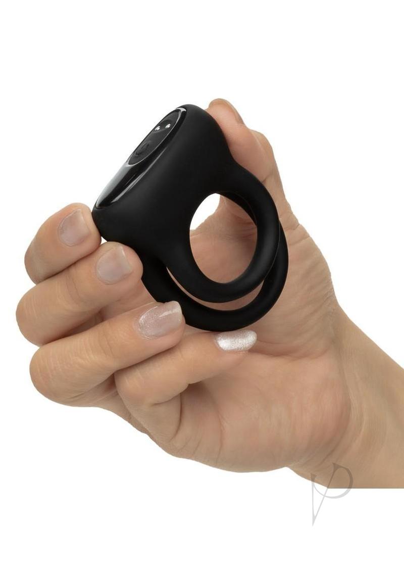 Pleasure Kits Power Play Collection Vibrator Kit Black dual enhancer ring in hand for customizable stimulation.