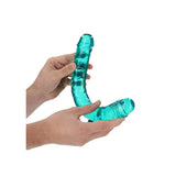 Realrock Crystal Clear Double Dong 13.4 inch Turquoise held in hands, showcasing its transparent turquoise design.