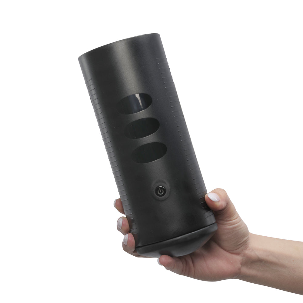 Kiiroo Titan Experience Interactive Vibrating Stroker held in hand showcasing its ergonomic design and control features.